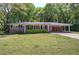 Charming single-story brick home featuring a covered carport and a well-maintained front yard at 4361 Stanley Dr, Powder Springs, GA 30127
