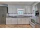 Well-lit kitchen featuring modern appliances and fixtures with a charming window and cabinet finishes at 4361 Stanley Dr, Powder Springs, GA 30127