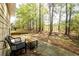 Back patio with wooded view and table and chairs at 742 Hope Hollow Ln, Loganville, GA 30052