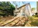 Two-story home featuring a backyard with a patio and view of mature trees at 742 Hope Hollow Ln, Loganville, GA 30052