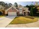 Charming two-story home featuring a brick facade, attached garage, and well-maintained front lawn at 742 Hope Hollow Ln, Loganville, GA 30052