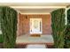 A charming front porch featuring brick accents, manicured bushes, and a welcoming front door at 742 Hope Hollow Ln, Loganville, GA 30052