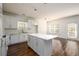 Bright kitchen with an island, white cabinets, and wood-look floors and modern fixtures at 742 Hope Hollow Ln, Loganville, GA 30052