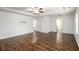 Open living room with wood floors, white walls, tray ceilings and two doors at 742 Hope Hollow Ln, Loganville, GA 30052