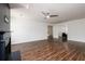 Living room features a ceiling fan, white walls, and dark wood-style flooring at 742 Hope Hollow Ln, Loganville, GA 30052