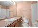 Bathroom showcasing a sink, toilet, and shower with peach-painted walls at 5908 Trent Walk Dr, Lithonia, GA 30038
