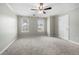 Bedroom with neutral paint, carpet, and two windows at 5908 Trent Walk Dr, Lithonia, GA 30038