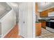 View of hallway and stairs that lead to the kitchen, which includes wood cabinets at 5908 Trent Walk Dr, Lithonia, GA 30038