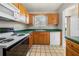 The kitchen features a window, wood cabinets and laminate countertops at 5908 Trent Walk Dr, Lithonia, GA 30038