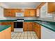 Functional kitchen featuring wood cabinets, laminate countertops, and modern appliances at 5908 Trent Walk Dr, Lithonia, GA 30038
