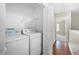 An interior laundry area with side-by-side washer and dryer, with upper shelf storage at 5908 Trent Walk Dr, Lithonia, GA 30038