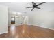 View of the open-concept living room, showcasing hardwood floors and stairs to the upper level at 5908 Trent Walk Dr, Lithonia, GA 30038