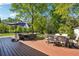 Inviting back deck with an umbrella offers comfortable seating and dining areas for outdoor enjoyment and entertaining at 1155 Christian Se Cir, Conyers, GA 30013