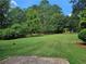 Expansive backyard with lush green grass and mature trees, providing ample space for outdoor activities at 1155 Christian Se Cir, Conyers, GA 30013