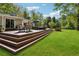 Outdoor dining on a multi-tiered deck, with ample seating and scenic views of the lush backyard at 1155 Christian Se Cir, Conyers, GA 30013