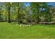 Expansive backyard features a lush green lawn and mature trees, offering a serene and private outdoor space at 1155 Christian Se Cir, Conyers, GA 30013