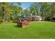 Large backyard with expansive lawn and wooden deck area, ideal for outdoor living at 1155 Christian Se Cir, Conyers, GA 30013