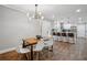 Charming dining room adjacent to the kitchen, featuring modern lighting and hardwood floors at 1155 Christian Se Cir, Conyers, GA 30013