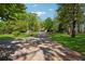 Long driveway leads to a charming home with a basketball hoop and sprawling front yard at 1155 Christian Se Cir, Conyers, GA 30013