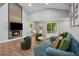 Cozy living room with a fireplace, comfortable seating, and a seamless transition to the outdoor patio at 1155 Christian Se Cir, Conyers, GA 30013