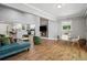 Open concept living room featuring a fireplace, modern kitchen, and hardwood floors at 1155 Christian Se Cir, Conyers, GA 30013