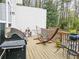 Relaxing back deck equipped with a grill, hammock, and outdoor seating amidst lush greenery at 2168 Rock Creek Park, Decatur, GA 30033