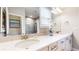 Bathroom featuring a double vanity with white cabinets, stone countertop, large mirror, and tiled shower at 2168 Rock Creek Park, Decatur, GA 30033