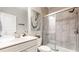 Well-lit bathroom features a vanity, toilet, and tiled shower with glass door, plus modern art on the wall at 2168 Rock Creek Park, Decatur, GA 30033