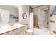 Bright bathroom featuring a shower-over-tub combination, a modern sink vanity, and decorative wall art at 2168 Rock Creek Park, Decatur, GA 30033