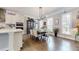 Dining room with hardwood floors, complemented by natural light and a stylish modern chandelier at 2168 Rock Creek Park, Decatur, GA 30033