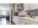 Updated kitchen features stainless steel appliances, mosaic backsplash, and an adjacent living area for seamless entertaining at 2168 Rock Creek Park, Decatur, GA 30033