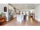 Contemporary kitchen features stainless steel appliances, large island, and hardwood floors, seamlessly flowing into the dining area at 2168 Rock Creek Park, Decatur, GA 30033