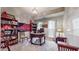 Office space with a round desk, bookshelves, two windows and a decorative sports flag at 2168 Rock Creek Park, Decatur, GA 30033