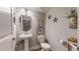 Charming powder room features pedestal sink, nautical decor, and a clean design for a stylish and functional space at 2168 Rock Creek Park, Decatur, GA 30033