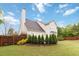 Large backyard with privacy fence, landscaping, and view of the home's exterior at 4264 Parks Ridge Dr, Snellville, GA 30039