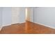 Clean bedroom with hardwood floors, white trim, closet, and bright doorway at 4264 Parks Ridge Dr, Snellville, GA 30039