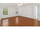 Bright bedroom features hardwood floors, two windows offering natural light, and a door leading to the bathroom at 4264 Parks Ridge Dr, Snellville, GA 30039