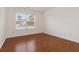 Simple bedroom features hardwood floors, a bright window, and a view of the outdoors at 4264 Parks Ridge Dr, Snellville, GA 30039