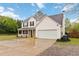 Beautiful home exterior featuring a two-car garage, manicured lawn, and inviting porch at 4264 Parks Ridge Dr, Snellville, GA 30039