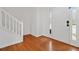 Welcoming foyer with hardwood floors and staircase, featuring a glass paneled front door at 4264 Parks Ridge Dr, Snellville, GA 30039