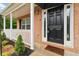 Close-up of the front door and porch, with brick accents and fresh landscaping at 4264 Parks Ridge Dr, Snellville, GA 30039