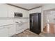 Modern kitchen featuring white cabinets, stainless steel appliances, and updated flooring for convenient cooking at 4264 Parks Ridge Dr, Snellville, GA 30039