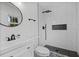 Bathroom features a modern sink, toilet, and a walk-in shower with a black-and-white tile pattern at 799 Kennesaw Dr, Forest Park, GA 30297