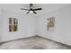 Bedroom features neutral walls, wood-look flooring, windows, and ceiling fan at 799 Kennesaw Dr, Forest Park, GA 30297