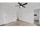 Bedroom boasts wood-look flooring, a ceiling fan, neutral walls, and a bathroom with a tiled shower at 799 Kennesaw Dr, Forest Park, GA 30297