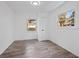 Bright bedroom with hardwood floors, white walls, neutral trim, and two sunny windows at 799 Kennesaw Dr, Forest Park, GA 30297
