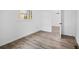 Bedroom with hardwood floors, white walls, neutral trim, bright window, and neutral door at 799 Kennesaw Dr, Forest Park, GA 30297