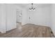 Dining room features wood-look flooring, modern light fixture, and white walls with neutral trim at 799 Kennesaw Dr, Forest Park, GA 30297