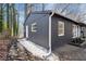 Home exterior featuring gray siding, white trim, and landscaping at 799 Kennesaw Dr, Forest Park, GA 30297