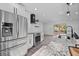 Modern kitchen with stainless appliances, granite countertops and island, plus white cabinets and a tile backsplash at 799 Kennesaw Dr, Forest Park, GA 30297